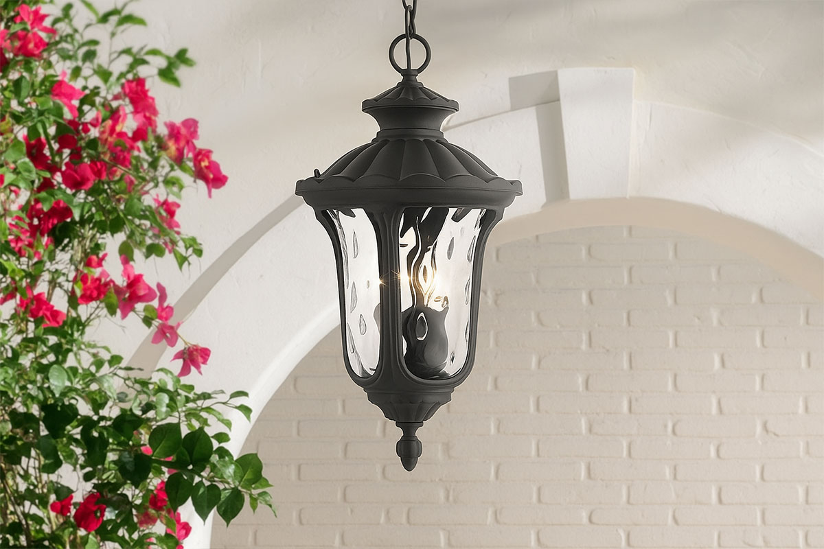 黒いアイアン製ランタンが白壁の前に吊るされた屋外照明